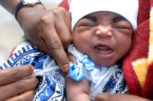 Baby grimaces as they get needle.
