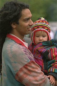 Adult holding young child in their arms.